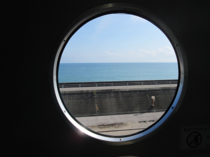 鉄道乗車記録の写真:車窓・風景(5)        「海沿いはとても良い景色でした、この丸い窓も良いですね!」