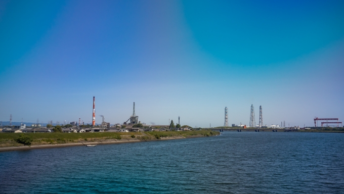 鉄道乗車記録の写真:車窓・風景(43)        「大野川の河口近く。
臨海工業地帯の煙突や造船所の大きなクレーンが目立ちます。」